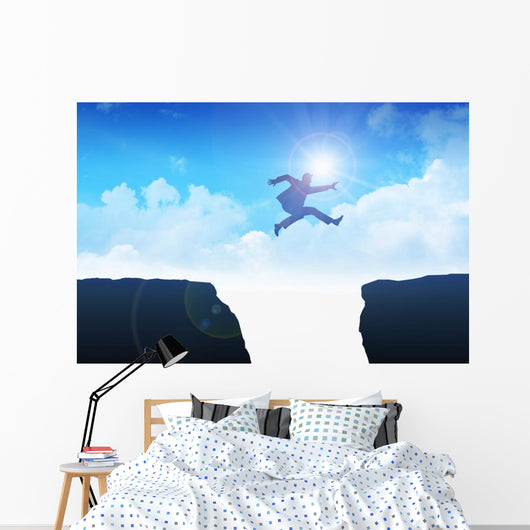 Man jumping over the ravine Wall Mural