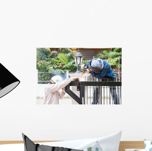 sparking worker side view Wall Mural