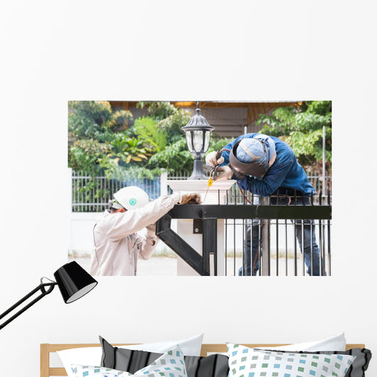 sparking worker side view Wall Mural