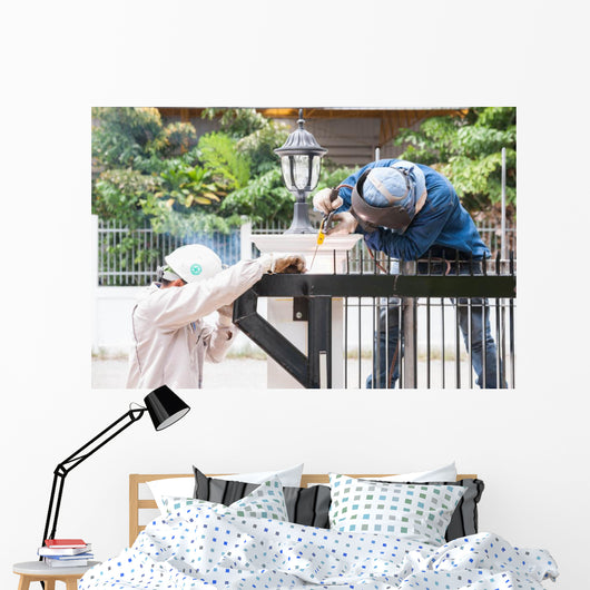 sparking worker side view Wall Mural