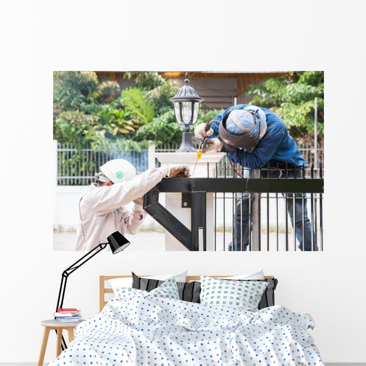 sparking worker side view Wall Mural