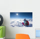 Hiker posing at top of snowy mountain during sunny day Wall Mural
