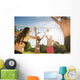 Friends play volleyball on the beach Wall Mural
