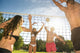 Friends play volleyball on the beach Wall Mural