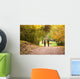 Young love couple, holding hands walking in the autumn forest Wall Mural