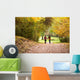 Young love couple, holding hands walking in the autumn forest Wall Mural