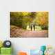 Young love couple, holding hands walking in the autumn forest Wall Mural