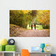 Young love couple, holding hands walking in the autumn forest Wall Mural
