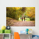Young love couple, holding hands walking in the autumn forest Wall Mural