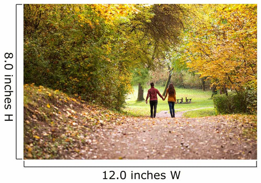 Young love couple, holding hands walking in the autumn forest Wall Mural