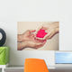 hands holding a red heart Wall Mural