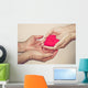 hands holding a red heart Wall Mural