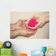 hands holding a red heart Wall Mural
