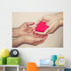 hands holding a red heart Wall Mural