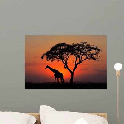 Silhouetted Tree and Giraffe Wall Mural shown on a wall