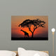 Silhouetted tree and giraffe against a red sunset Wall Mural