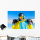 Snowboarder holding snowboard Wall Mural