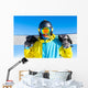 Snowboarder holding snowboard Wall Mural