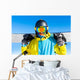 Snowboarder holding snowboard Wall Mural