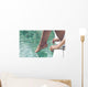 Young Woman Sitting at Poolside with Toes on Water Wall Mural