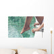 Young Woman Sitting at Poolside with Toes on Water Wall Mural