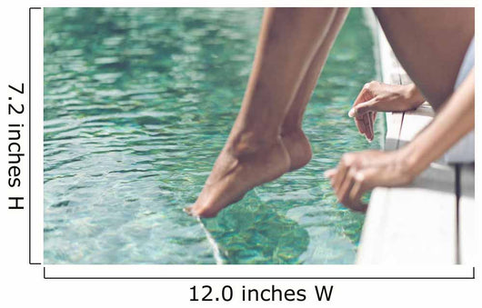 Young Woman Sitting at Poolside with Toes on Water Wall Mural