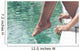 Young Woman Sitting at Poolside with Toes on Water Wall Mural