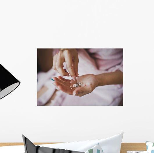 Earrings from pearls in hands 1278. Wall Mural