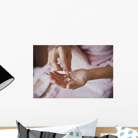 Earrings from pearls in hands 1278. Wall Mural