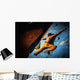 Muscular man practicing rock-climbing on a rock wall indoors Wall Mural