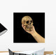 Holding human skull in hand. Conceptual image. Wall Mural