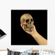 Holding human skull in hand. Conceptual image. Wall Mural