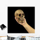 Holding human skull in hand. Conceptual image. Wall Mural