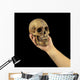 Holding human skull in hand. Conceptual image. Wall Mural