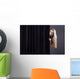 Frightened girl hiding behind a curtain. Wall Mural