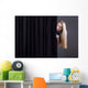Frightened girl hiding behind a curtain. Wall Mural