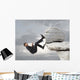 Young businessman scaling a rock Wall Mural