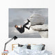 Young businessman scaling a rock Wall Mural
