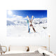 Skiing , mountains and ski equipments on ski run Wall Mural