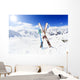 Skiing , mountains and ski equipments on ski run Wall Mural