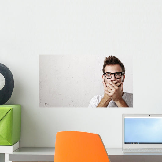 Shocked man covering his mouth with hands Wall Mural