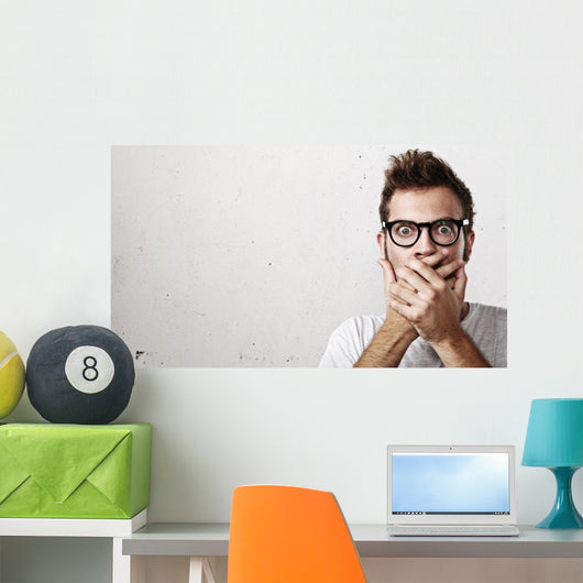 Shocked man covering his mouth with hands Wall Mural