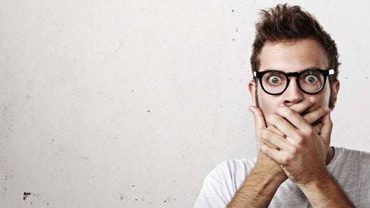 Shocked man covering his mouth with hands Wall Mural