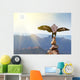 Wedge-tailed Eagle landing on rock cairn on mountain top Wall Mural