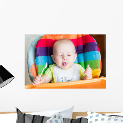 Adorable Baby Eating High Wall Mural shown on a wall