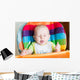 Adorable baby eating in high chair Wall Mural