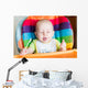Adorable baby eating in high chair Wall Mural
