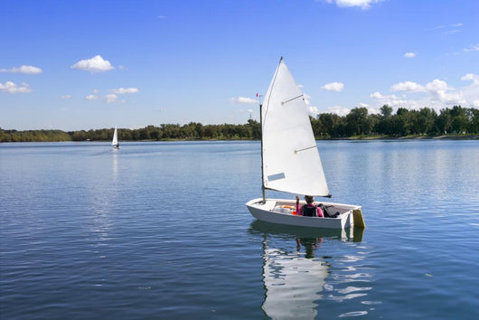 White boat sailing Wall Mural