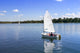 White boat sailing Wall Mural