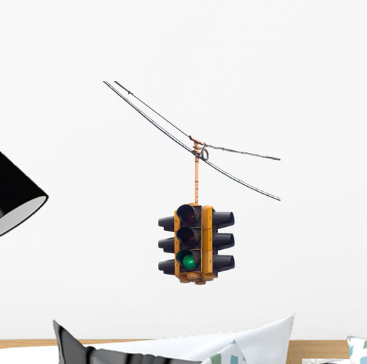 Green traffic light hanging from a cable, isolated on white. Wall Decal